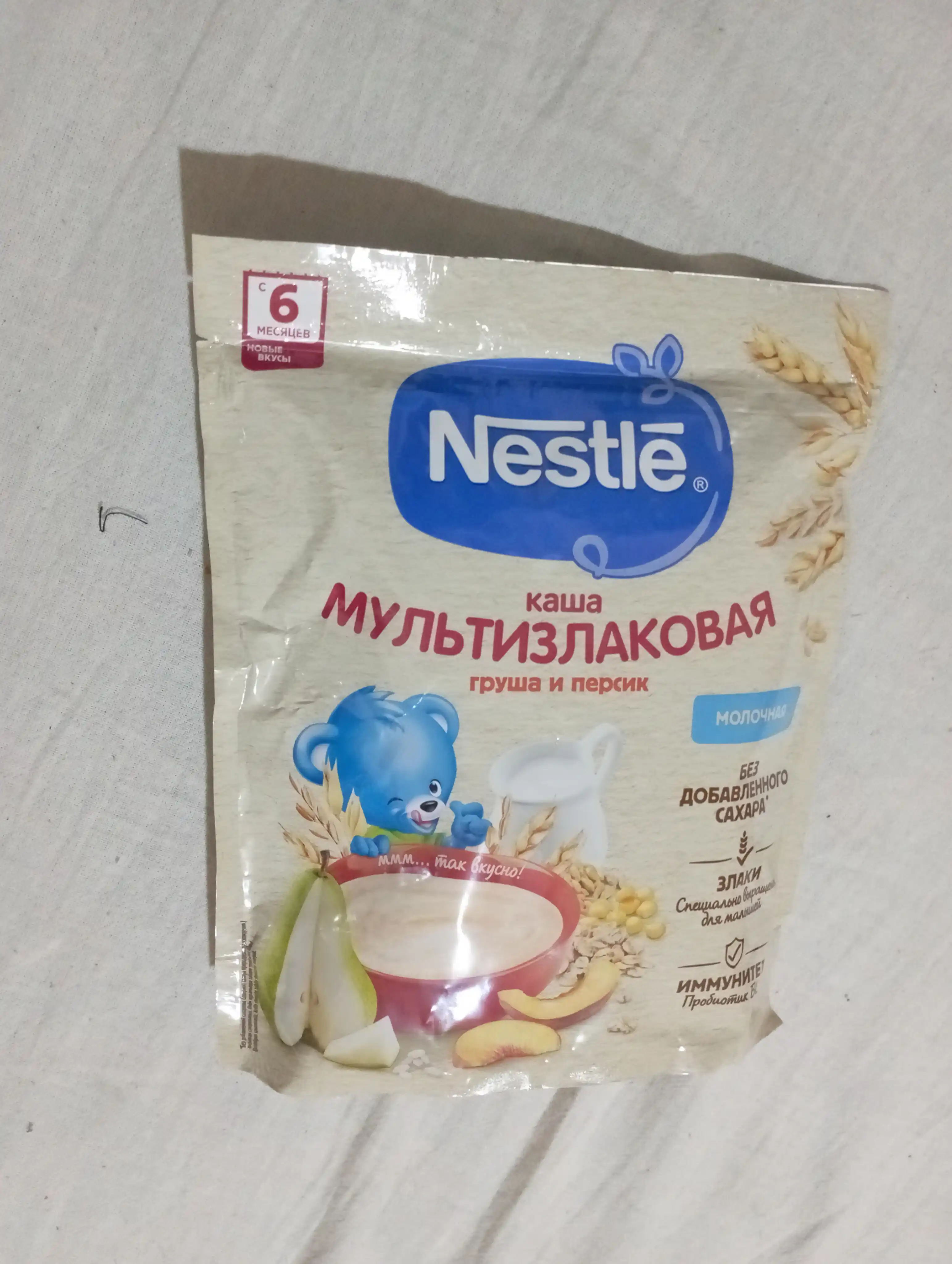 NESTLE® sutli ko‘pzraxli bo‘tqa, nok va shaftoli bilan, 6 oylikdan boshlab, 200 g