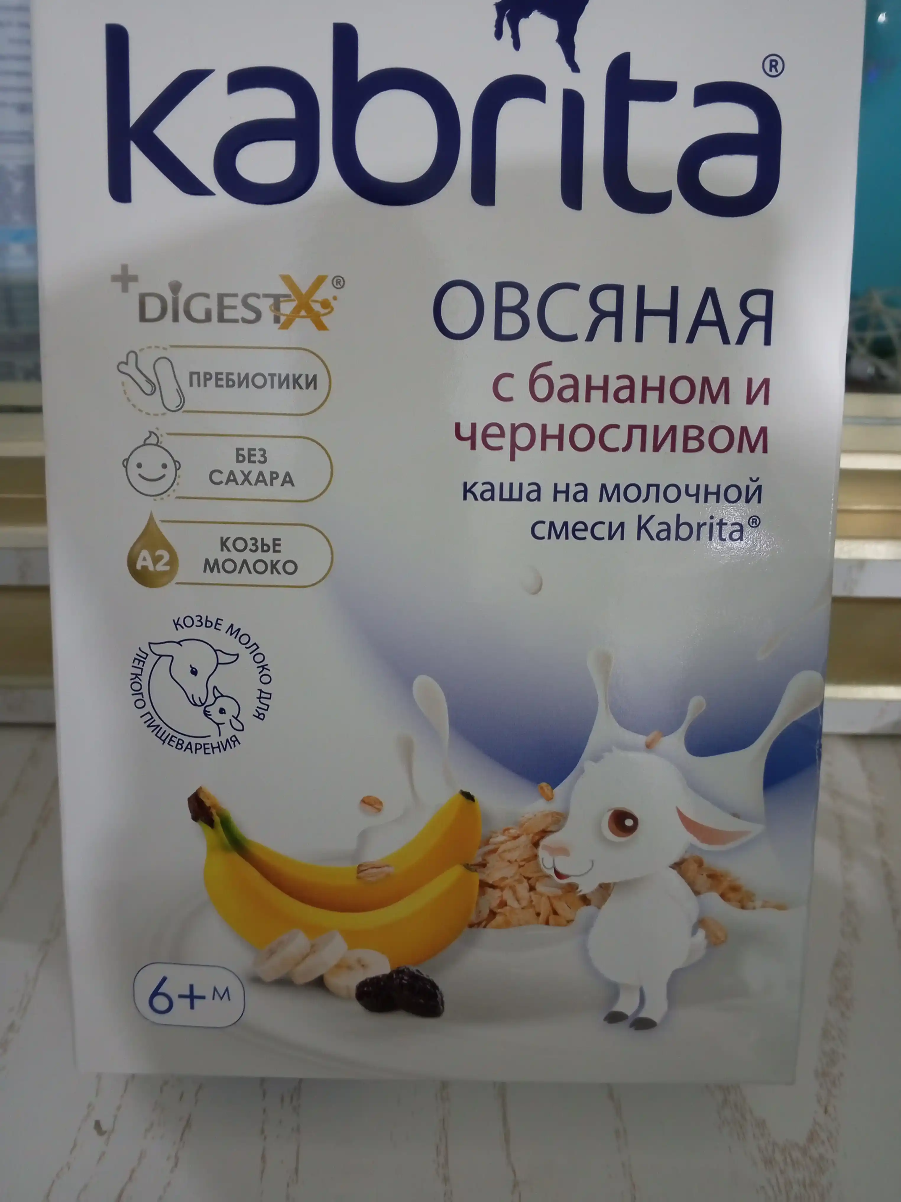 Ovsyanka bo'tqasi Kabrita, banan va qora olxo'ri bilan echki sutida 6 oy bilan, 180 gr
