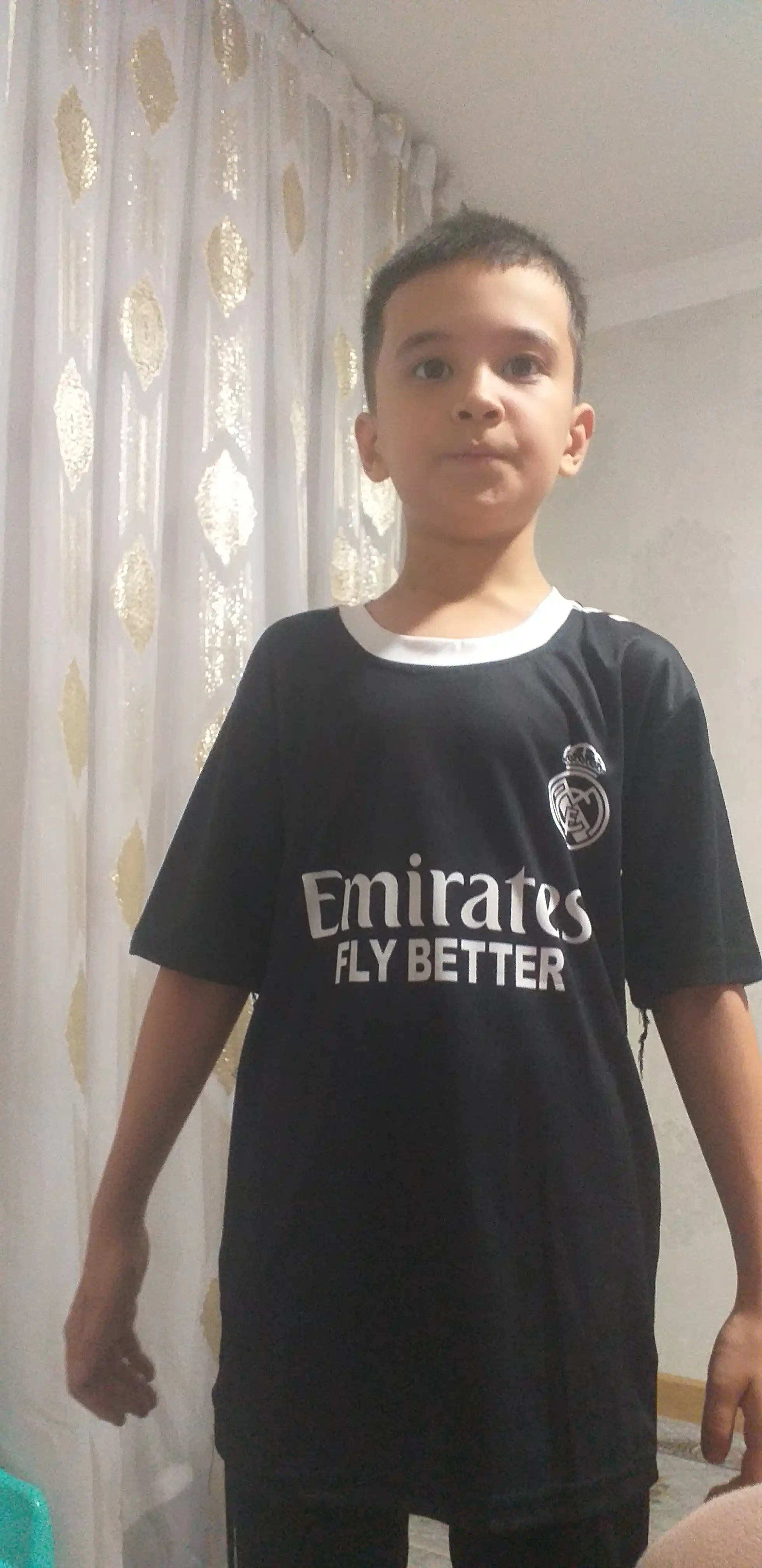 Mbappe, Lamin Yamal, Ronaldo va Husanov tasvirlangan bolalar futbolkalari